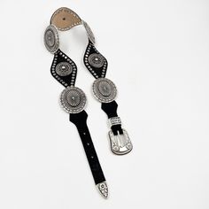 Indulge in the elegant and exclusive style with our Lyra Concho Belt. Made from luxurious black Italian leather, this western-style belt features intricate silver concho hardware and stud details. The silver buckle set adds the perfect finishing touch. Elevate any outfit and make a statement with this sophisticated accessory. Details: Smooth black Italian leather Silver plated buckle set and hardware Sourced in Italy Made in California