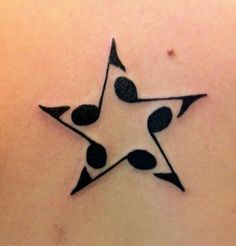 a black and white star tattoo on the back of a woman's upper body