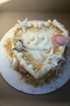 a heart shaped cake with seashells and starfish on it