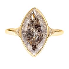 a yellow gold ring with a brown and white diamond