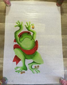 an image of a green frog on a white towel