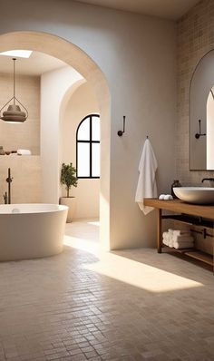 a large white bath tub sitting next to a sink in a bathroom under two mirrors