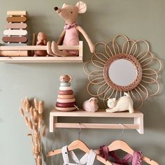 two wooden shelves with clothes and toys on them