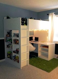 a bedroom with a loft bed, desk and bookshelf in the corner next to a window