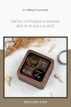 a wooden box with two rings in it and the words metal cufflinks & square box w glass lid set