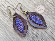 These boho genuine leather tribal drop earrings are a stylish choice for both casual and dressed-up looks.  Handmade with excellent quality leather, the unique brown and blue design adds a timeless accent to your outfit, perfect for any occasion, from parties to festivals. Approximate Dimensions: Length 2 in / 5 cm Width 0.9 in / 2.5 cm Bohemian Hand-tooled Drop Earrings, Bohemian Leather Drop Earrings, Bohemian Leather Teardrop Earrings, Blue Bohemian Hand-tooled Earrings, Bohemian Teardrop Leather Earrings, Blue Bohemian Leather Earrings, Bohemian Blue Leather Earrings, Blue Leather Bohemian Earrings, Bohemian Leather Earrings