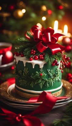 a green christmas cake decorated with holly and red berries on a plate next to a lit candle