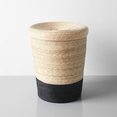 a black and white cup sitting on top of a table