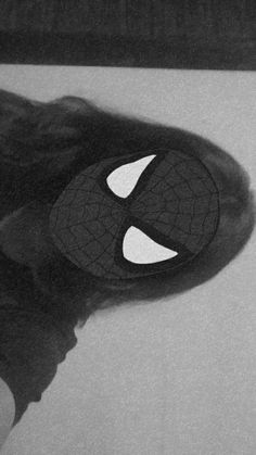 a black and white photo of someone's feet with a spider - man mask on