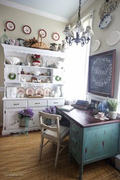 the french farmhouse kitchen is decorated in white and blue with lots of dishes on it