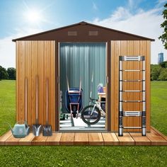 a small wooden shed sitting on top of a lush green field next to a watering can