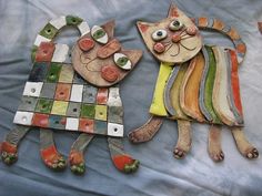 two cats made out of different colored tiles