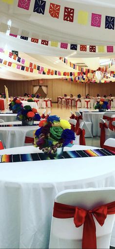 tables and chairs are decorated with colorful ribbons