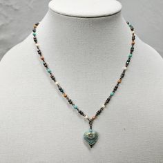 A beautiful, unique Czech Beaded Necklace that is eye-catching! Give this wonderful piece of jewelry as a gift for your mom, wife, or girlfriend.  SIZE  *Necklace Length - 18-24 inches *Pendant height - 1 inches *Pendant width - ¾ inches  ITEM DETAILS  *Material - Glass AQUA HEART WITH 3 COLOR CHAIN  *       A beautiful pressed Czech glass matte aqua opaque heart with a complementing goldish wash finish. *The chain is a 4mm multi-color beaded Czech chain with antique brass wire connecting the ch Elegant Heart-shaped Colorful Beads Jewelry, Elegant Heart-shaped Jewelry With Colorful Beads, Elegant Heart-shaped Colorful Beaded Jewelry, Blue Heart-shaped Beaded Chain Jewelry, Turquoise Beaded Heart Pendant Jewelry, Double Heart Beads Necklaces For Jewelry Making, Adjustable Heart Necklace With Heart Beads And Pendant, Adjustable Heart Pendant Necklace With Heart Beads, Blue Heart-shaped Spiritual Necklace