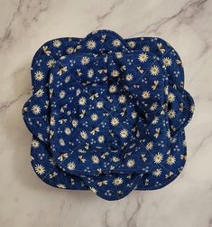 a blue and white flowered cloth on a marble surface