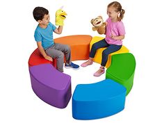 two children sitting on brightly colored chairs with stuffed animals in the middle and one holding a teddy bear