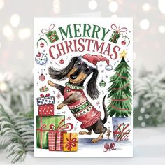 a christmas card with a dachshund dog wearing a sweater and holding presents