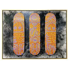 three skateboards with designs on them sitting next to each other