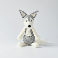 a crocheted stuffed animal sitting on the ground