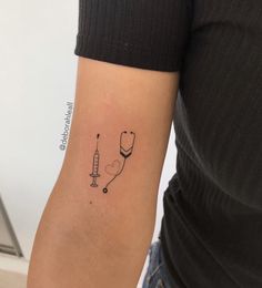 a woman's arm with a tattoo on it and a stethoscope