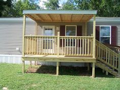 a mobile home with a porch and deck