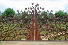 a large metal gate with trees on it