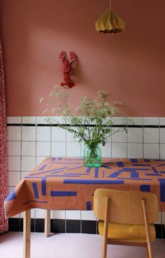 a vase with flowers on top of a table