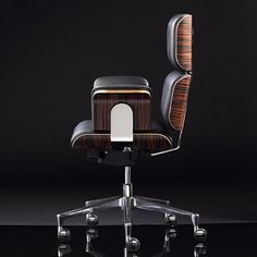 an office chair with wooden back and seat upholstered to the side, sitting on casteors