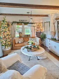 a living room filled with furniture and a christmas tree