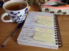 a cup of coffee and some notes on a table