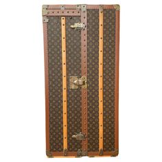 an old suitcase with wooden handles and rivets on the front is shown against a white background