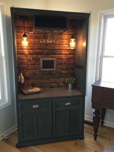 an old hutch has been converted into a tv stand with built - in lighting