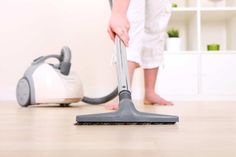 a person using a vacuum cleaner on the floor