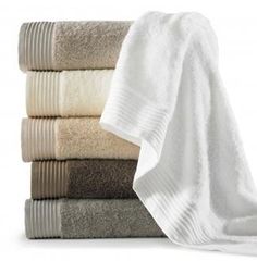 towels stacked on top of each other in different colors and sizes, with one folded