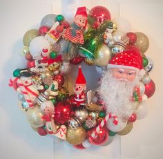 a christmas wreath with santa claus and other ornaments