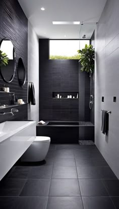 a black and white bathroom with two sinks, a toilet and a bathtub in it