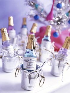 several bottles of champagne sitting in buckets on a table