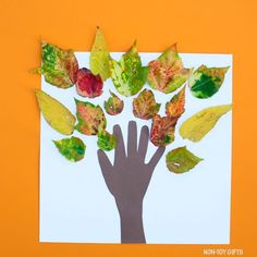 leaf and handprint fall tree craft on an orange background with the words leaf & handprint fall tree craft