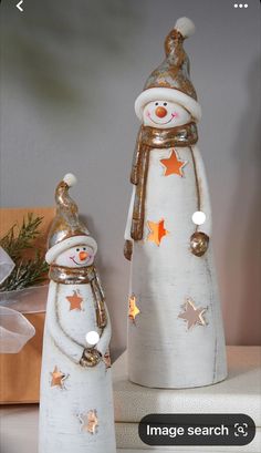 two snowmen are standing next to each other