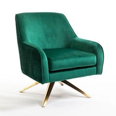 a green velvet chair with gold legs