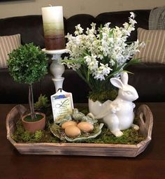 a tray with flowers, eggs and an easter decoration