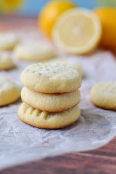 several cookies stacked on top of each other with lemons in the backround