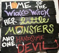 some wooden signs with writing on them that say home of the weird witch and little monsters