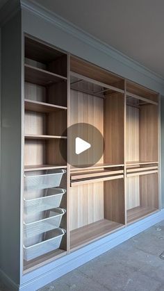 a walk in closet with wooden shelves and white baskets