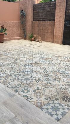 an outdoor area with tile and potted plants