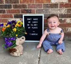 a baby sitting on the ground next to a potted plant and sign that says don't make me laugh or till wet my plants