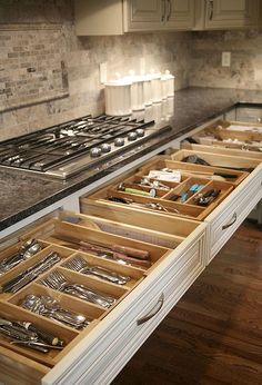 an open drawer in the middle of a kitchen counter