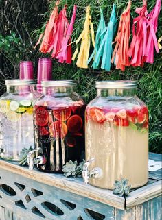 several jars filled with liquid sitting on top of a table