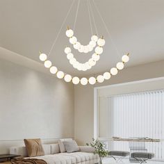 a living room filled with furniture and a chandelier hanging from it's ceiling