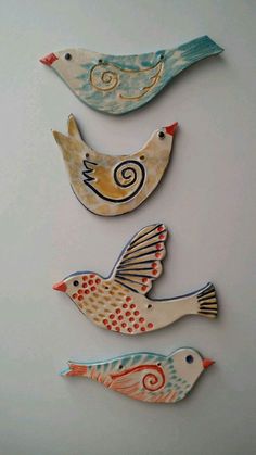 three ceramic birds sitting next to each other